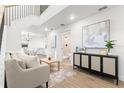 Bright living room featuring wood floors, modern decor, and open staircase at 7422 S 34Th Ave, Tampa, FL 33619