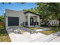 Contemporary home featuring a sleek design and attached garage at 3715 E Clifton St, Tampa, FL 33610