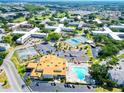 Aerial view of community featuring pool, tennis courts, and numerous buildings at 2285 Israeli Dr # 29, Clearwater, FL 33763