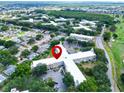 Aerial view of an apartment building in a residential area with golf course nearby at 2285 Israeli Dr # 29, Clearwater, FL 33763