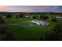 Beautiful aerial view of a sprawling country estate with lush green fields and a long winding driveway at 36431 Florrie Mae Ln, Dade City, FL 33523