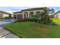 House exterior featuring a nicely landscaped front yard at 4204 Woods Rider Loop, Odessa, FL 33556