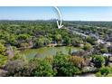Scenic aerial view overlooking a serene lake with the downtown skyline in the distance at 5530 N 9Th St # 3, Tampa, FL 33604