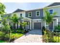 Inviting new construction townhome with gray brick paver driveway and lush green landscaping at 5530 N 9Th St # 3, Tampa, FL 33604