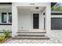 Covered front porch with dark door and gray pavers at 2722 W Dewey St, Tampa, FL 33607