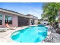 Inviting pool and spa area with lounge chairs and palm trees at 33310 Azalea Ridge Dr, Wesley Chapel, FL 33545