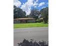 Ranch style home with a spacious lawn and mature trees at 5023 6Th St, Zephyrhills, FL 33542