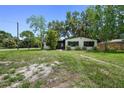 Front yard view of a renovated house with a spacious lawn at 5202 23Rd S Ave, Gulfport, FL 33707