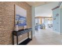 Elegant entryway with decorative wall and modern console table at 130 Riviera Dunes Way # 403, Palmetto, FL 34221