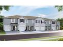 Three-story townhouses with attached garages and landscaping at 5026 Captain Davis Dr, Wimauma, FL 33598