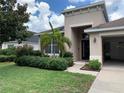 House exterior view with palm trees and manicured lawn at 10308 Holland Rd, Riverview, FL 33578