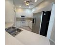 Bright kitchen with stainless steel appliances and ample cabinet space at 1178 Green Oak Trl, Port Charlotte, FL 33948