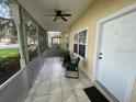 Screened porch with tile floor and seating area at 1178 Green Oak Trl, Port Charlotte, FL 33948