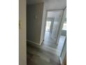 Bright hallway with light gray vinyl plank flooring leading to other rooms at 14105 Mossy Glen Ln # 202, Tampa, FL 33613