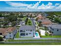 Aerial view of waterfront home with pool and private dock, located near Tampa Bay at 517 Treviso Dr, Apollo Beach, FL 33572