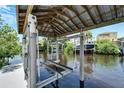 Covered boat lift with spacious dock, perfect for waterfront living at 519 Treviso Dr, Apollo Beach, FL 33572