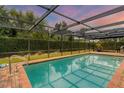 Relaxing screened-in pool with brick pavers surrounding it at 4302 Deepwater Ln, Tampa, FL 33615