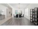 Elegant dining room featuring a wood-look floor and a chandelier at 9661 Gretna Green Dr, Tampa, FL 33626