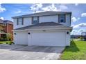 Two-story house with a two-car garage and a landscaped yard at 20131 Nob Oak Ave, Tampa, FL 33647