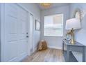 Bright and airy entryway with light gray console table and white door at 20131 Nob Oak Ave, Tampa, FL 33647