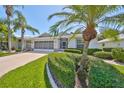 Single-story home with a two-car garage and well-manicured lawn at 812 Mccallister Ave, Sun City Center, FL 33573