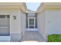 Inviting front entry with a screened door and brick walkway at 812 Mccallister Ave, Sun City Center, FL 33573