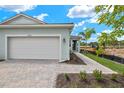 Single car garage with paver driveway and walkway at 20303 Symphony Pl, Venice, FL 34293