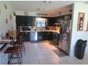 Retro kitchen with dark cabinets, wood countertop, and stainless steel appliances at 10311 Us Highway 98, Dade City, FL 33525