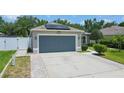 Front view of house with gray garage door and solar panels at 4504 Horseshoe Pick Ln, Valrico, FL 33594