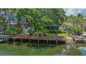 Charming home with a dock, lush landscaping, and private backyard at 5369 Tuscawilla Dr, Weeki Wachee, FL 34607