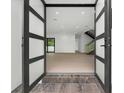 Open concept entryway with modern double doors and hardwood floors at 5341 Lake Pearl Ct, Tampa, FL 33625