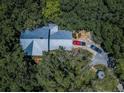 Aerial view showcasing a home's metal roof and driveway at 2271 Keystone Rd, Tarpon Springs, FL 34688