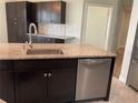 Modern kitchen with dark cabinets, granite counters and stainless steel appliances at 4115 Murfield E Dr, Bradenton, FL 34203