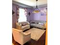 Elegant living room with purple walls and plush furniture at 32502 Summerglade Dr, Wesley Chapel, FL 33545