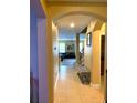 Bright entryway with tile floors and view of living room at 32502 Summerglade Dr, Wesley Chapel, FL 33545