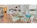 Kitchen and dining area with glass table and seashell patterned chairs at 308 S Port Royal Ln, Apollo Beach, FL 33572