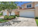 View of townhome building, showing garages and landscaping at 184 Valencia Cir, St Petersburg, FL 33716