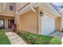 Townhome entrance with walkway, landscaping, and garage at 184 Valencia Cir, St Petersburg, FL 33716
