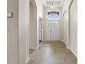 Bright and airy entryway with tile flooring and a view to the living room at 31421 Anniston Dr, Wesley Chapel, FL 33543