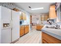 Kitchen with wood cabinets and laminate flooring at 37700 Neukom Ave, Zephyrhills, FL 33541