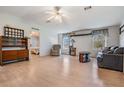 Spacious living room with light wood floors and a ceiling fan at 37700 Neukom Ave, Zephyrhills, FL 33541