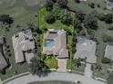 Aerial view of the property highlighting the private pool, screened lanai, and well-maintained yard at 13216 Legends Trl, Dade City, FL 33525