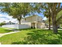 Two-story house with a white fence and a palm tree in the front yard at 17350 Garden Heath Ct, Land O Lakes, FL 34638