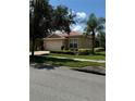 Tan house with a red tile roof and two car garage at 15953 Cobble Mill Dr, Wimauma, FL 33598