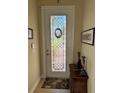 Entryway with decorative glass door and small table at 15953 Cobble Mill Dr, Wimauma, FL 33598