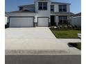 Inviting two-story home with a three-car garage and a well-manicured lawn at 18320 Fattoria Ter, Lakewood Ranch, FL 34211