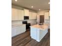 Modern kitchen features white cabinets, marble countertops, and stainless steel appliances at 18320 Fattoria Ter, Lakewood Ranch, FL 34211