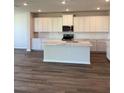 Modern kitchen features white cabinets, marble countertops, and stainless steel appliances at 18320 Fattoria Ter, Lakewood Ranch, FL 34211