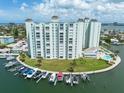 Aerial view of waterfront property with boat slips and pool at 400 64Th Ave # 704, St Pete Beach, FL 33706