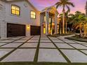 Two-car garage and a paved driveway with grass accents at 780 Eldorado Ave, Clearwater, FL 33767